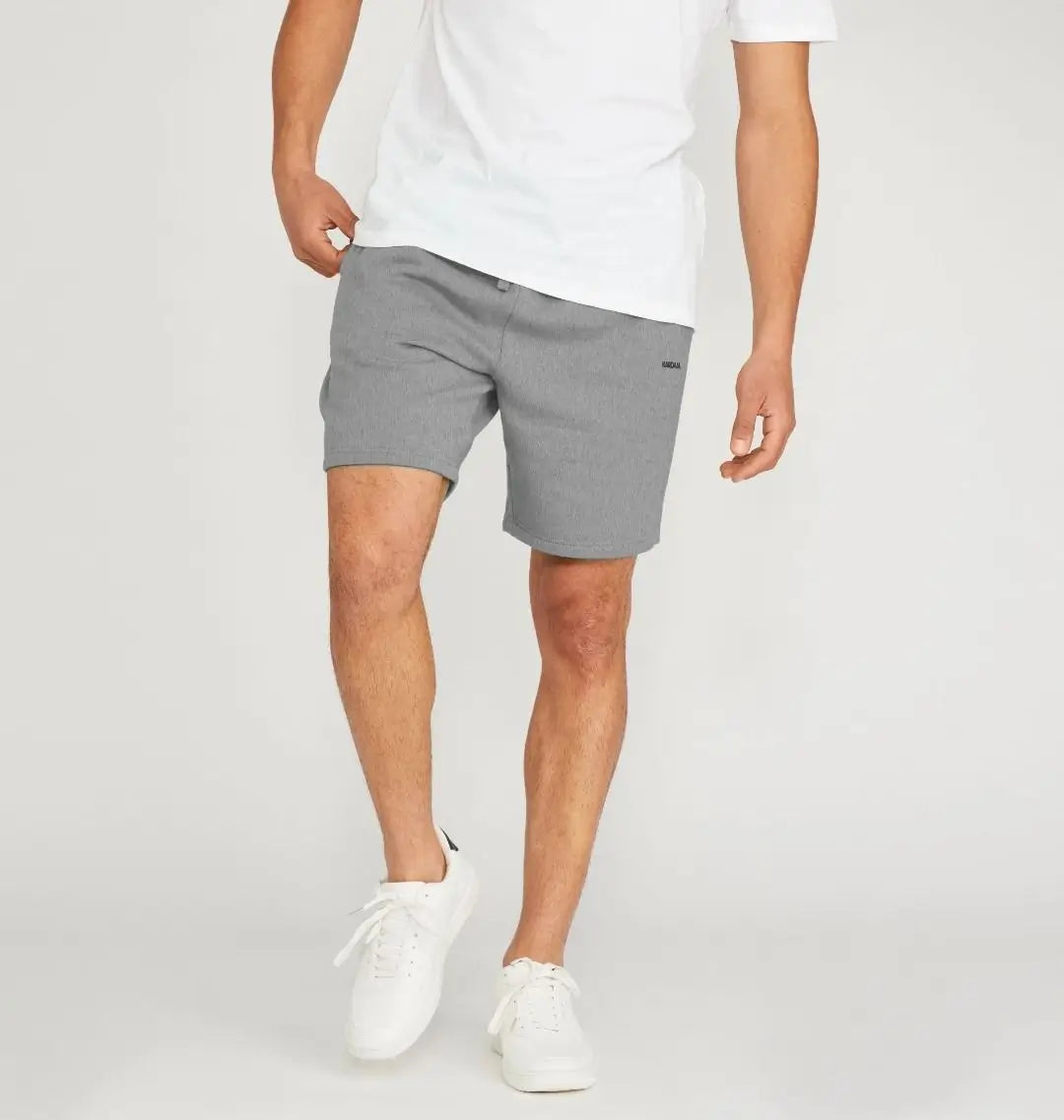 Short gris en coton bio porté par un homme de dos avec baskets blanches